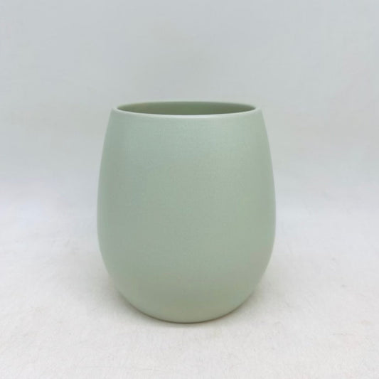 The Friendly Face cucumber green matte planter with a smooth rounded shape, shown on a white background.