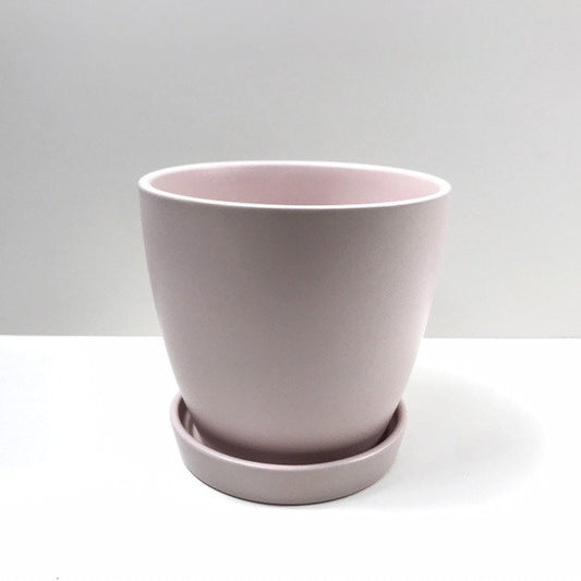 The Good Influence pale pink planter with matching saucer, shown against a white backdrop.