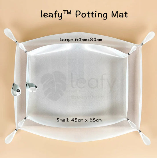 White potting mat with 'leafy' branding on a beige background