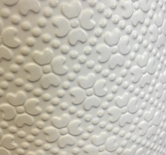 Close-up detail of the textured ceramic surface on The Comfort Zone white planter.