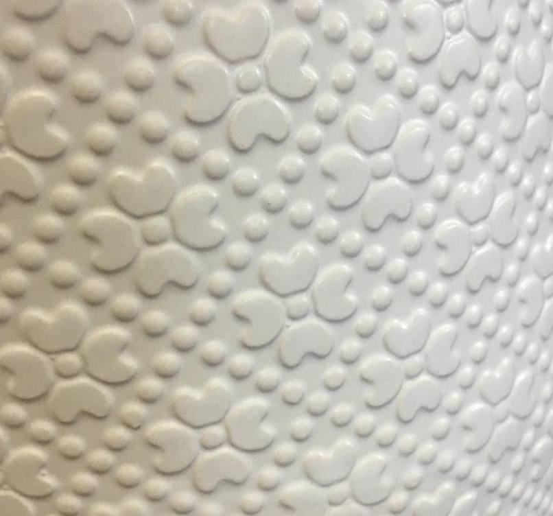 Close-up detail of the textured ceramic surface on The Comfort Zone white planter.