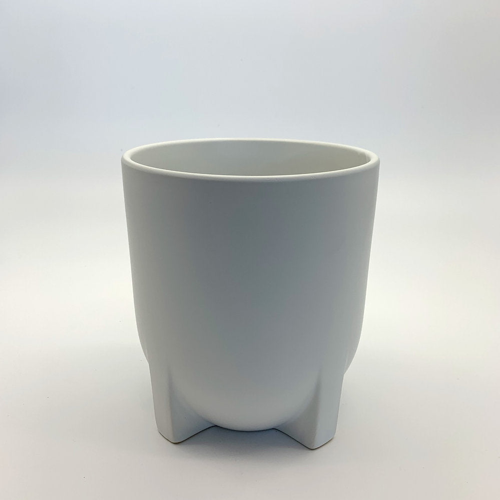 The Easy Keeper white satin-matte ceramic planter featuring short, squat legs and a smooth rounded shape, photographed on a clean gradient background.