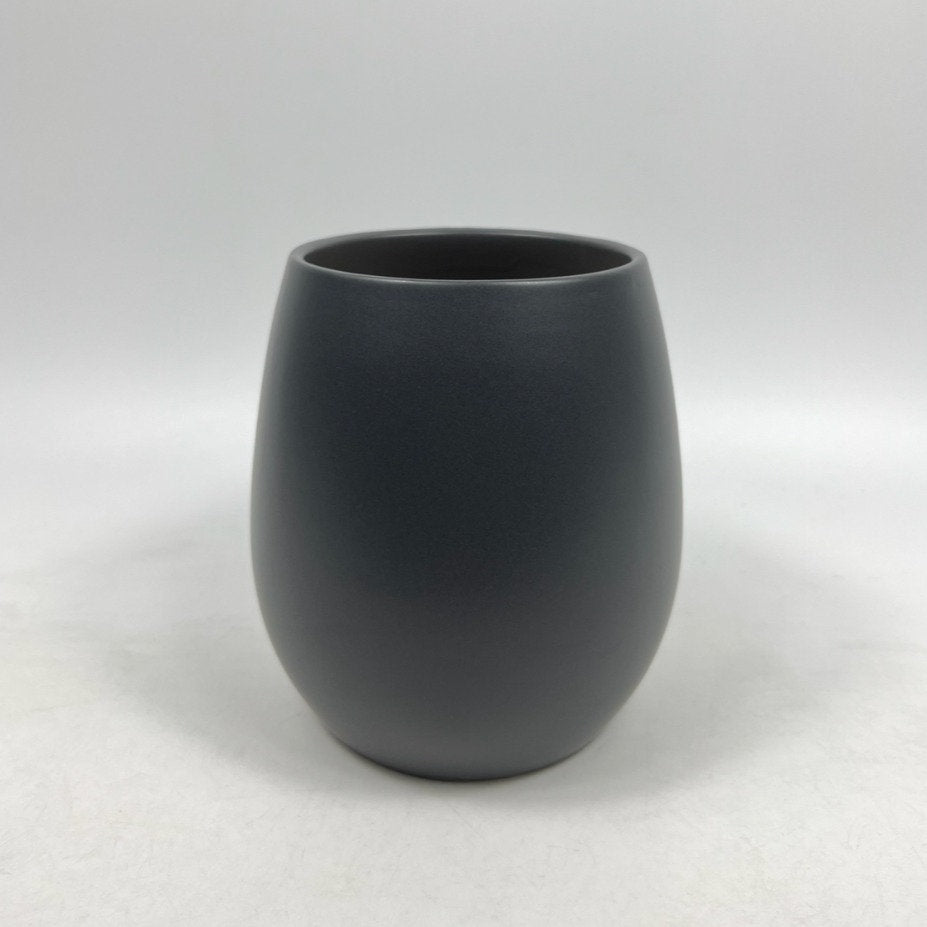 The Friendly Face charcoal matte planter with a rounded, modern silhouette photographed against a white backdrop.