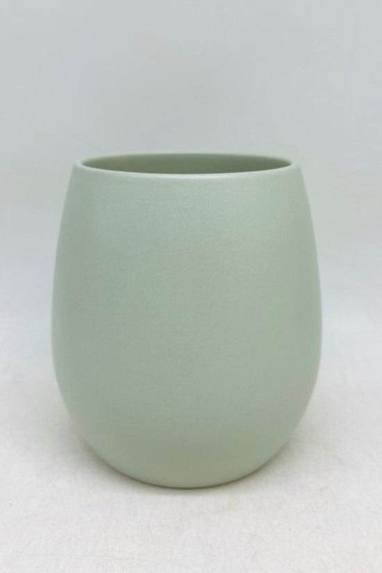 The Friendly Face cucumber green matte planter with a smooth rounded shape, shown on a white background.