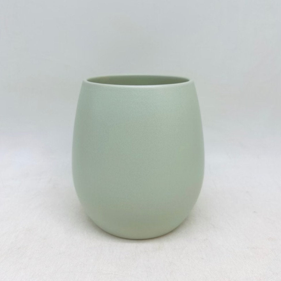 The Friendly Face cucumber green matte planter with a smooth rounded shape, shown on a white background.