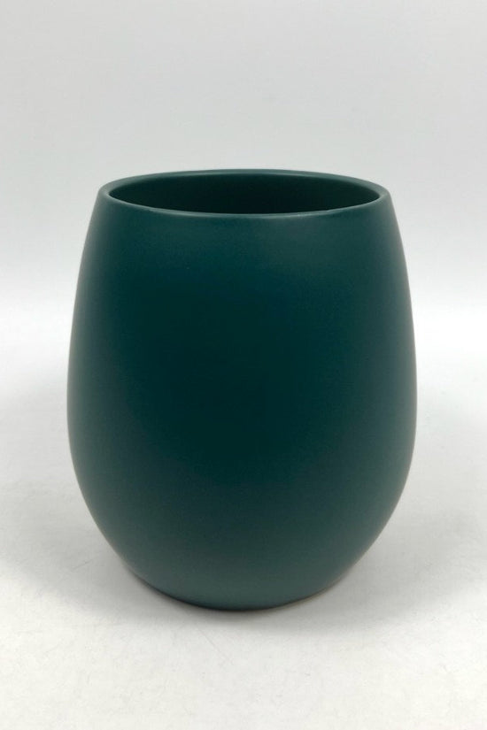 The Friendly Face teal matte planter with a rounded silhouette, photographed on a clean white background.