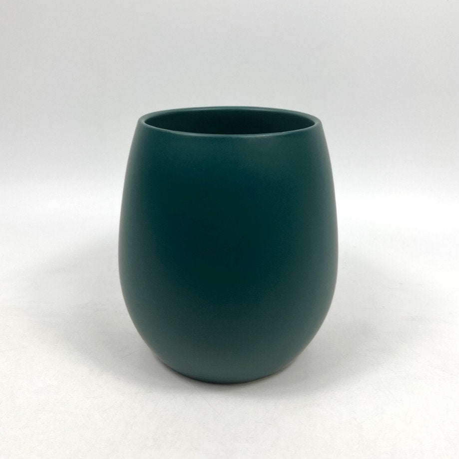 The Friendly Face teal matte planter with a rounded silhouette, photographed on a clean white background.