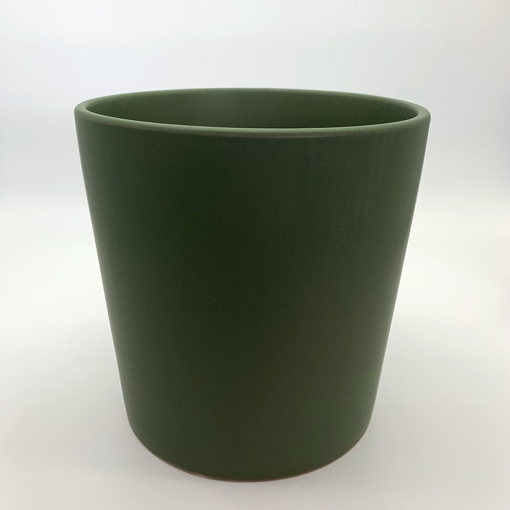 The Glow Getter avocado green glazed ceramic planter with a smooth glossy finish, photographed on a clean white background.