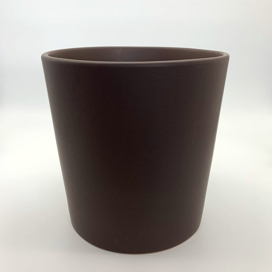 The Glow Getter chocolate brown glazed ceramic planter with a modern rounded shape, shown on a neutral white backdrop.