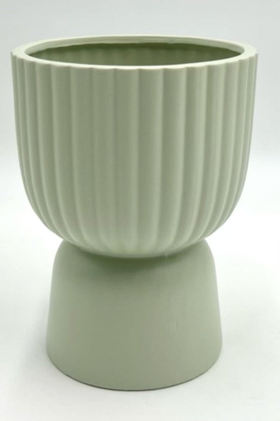 The Good Egg cucumber green ribbed planter with a raised pedestal base, photographed on a clean white background.