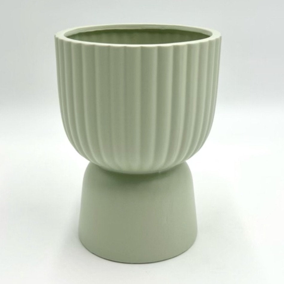 The Good Egg cucumber green ribbed planter with a raised pedestal base, photographed on a clean white background.