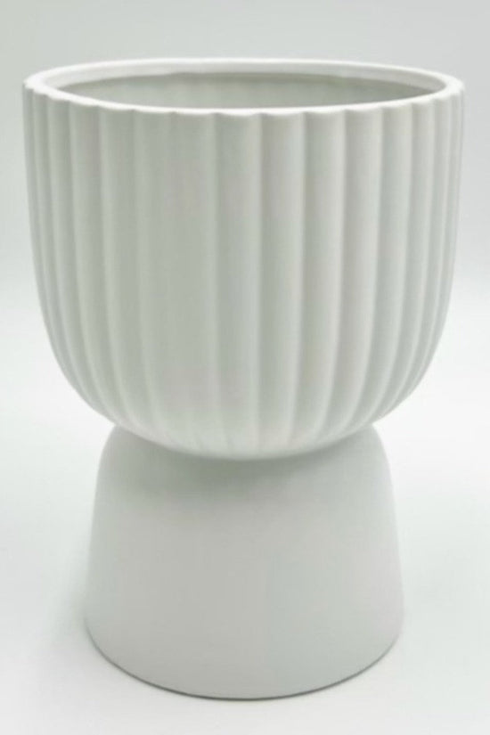 The Good Egg white ribbed planter on a raised pedestal base, photographed on a clean white background.