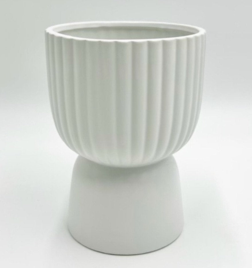 The Good Egg white ribbed planter on a raised pedestal base, photographed on a clean white background.