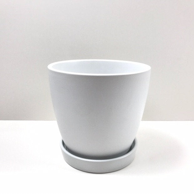 The Good Influence white pot-and-saucer set with a smooth matte finish, photographed against a white backdrop.