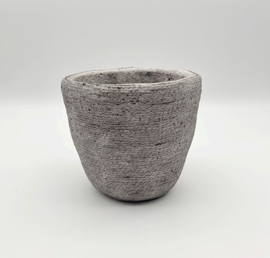 The Loyal One textured stone-look planter with a softly rounded shape, photographed on a clean white background.
