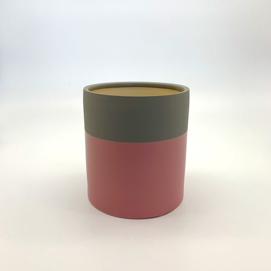 The Mood Booster planter featuring a matte two-tone colour-block design in pink and olive, photographed on a clean white background.