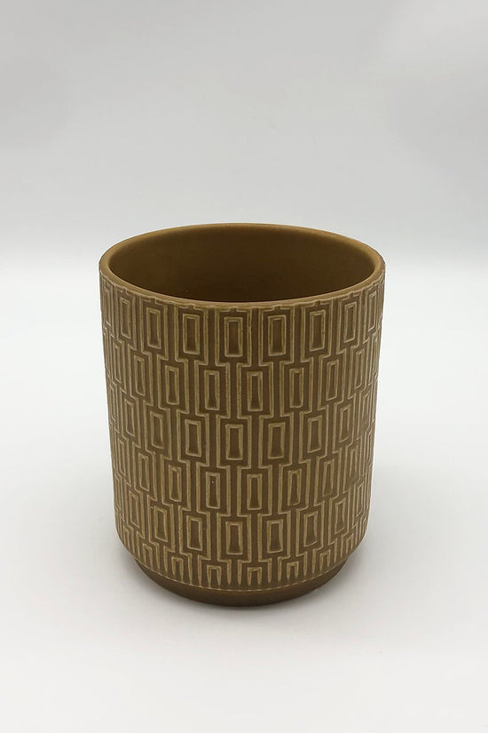 The Side Table Star planter in mustard brown with textured geometric surface on a white backdrop.