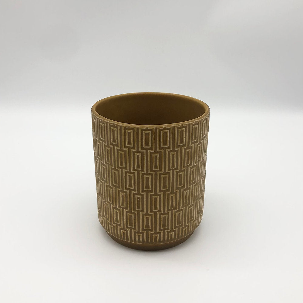 The Side Table Star planter in mustard brown with textured geometric surface on a white backdrop.