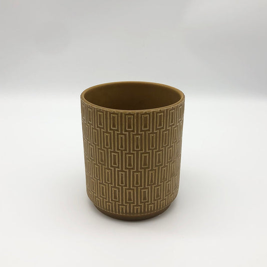 The Side Table Star planter in mustard brown with textured geometric surface on a white backdrop.