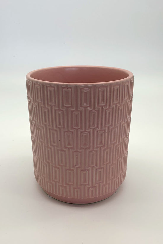 The Side Table Star planter in soft pink glaze with geometric texture photographed on white.