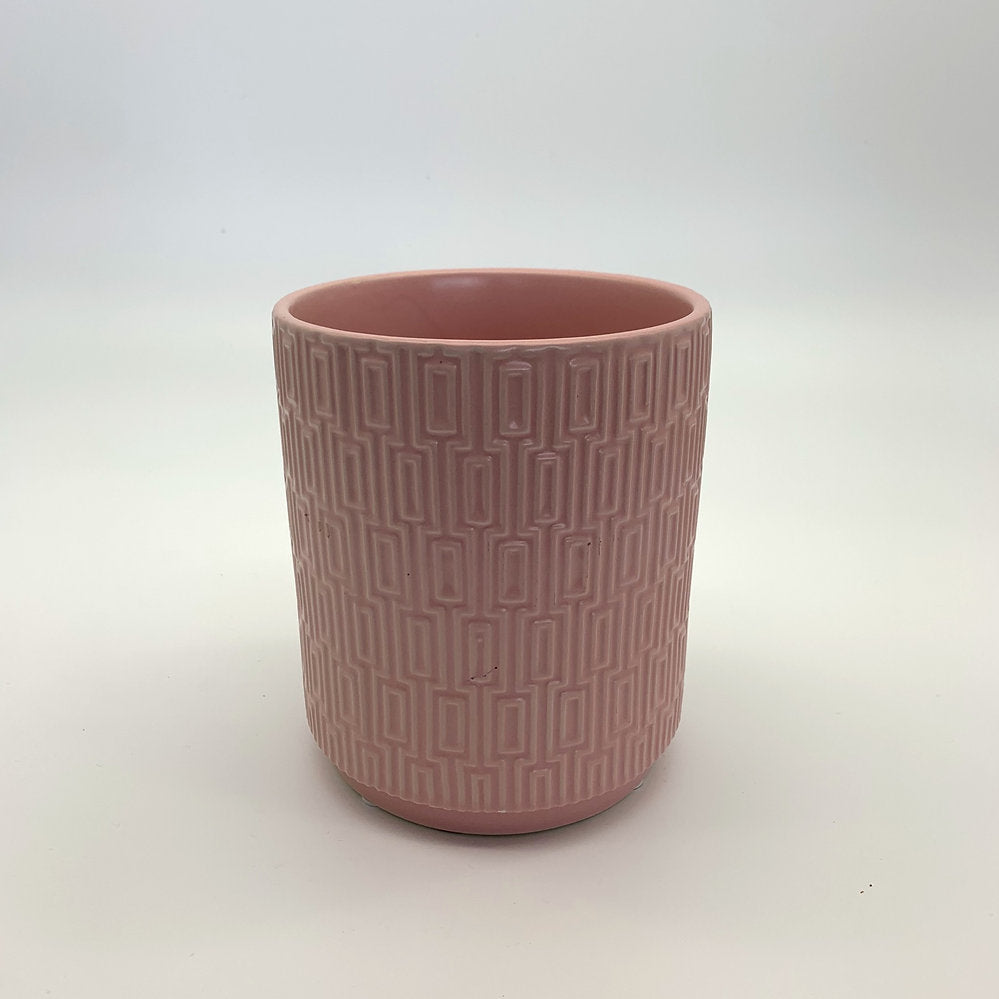 The Side Table Star planter in soft pink glaze with geometric texture photographed on white.