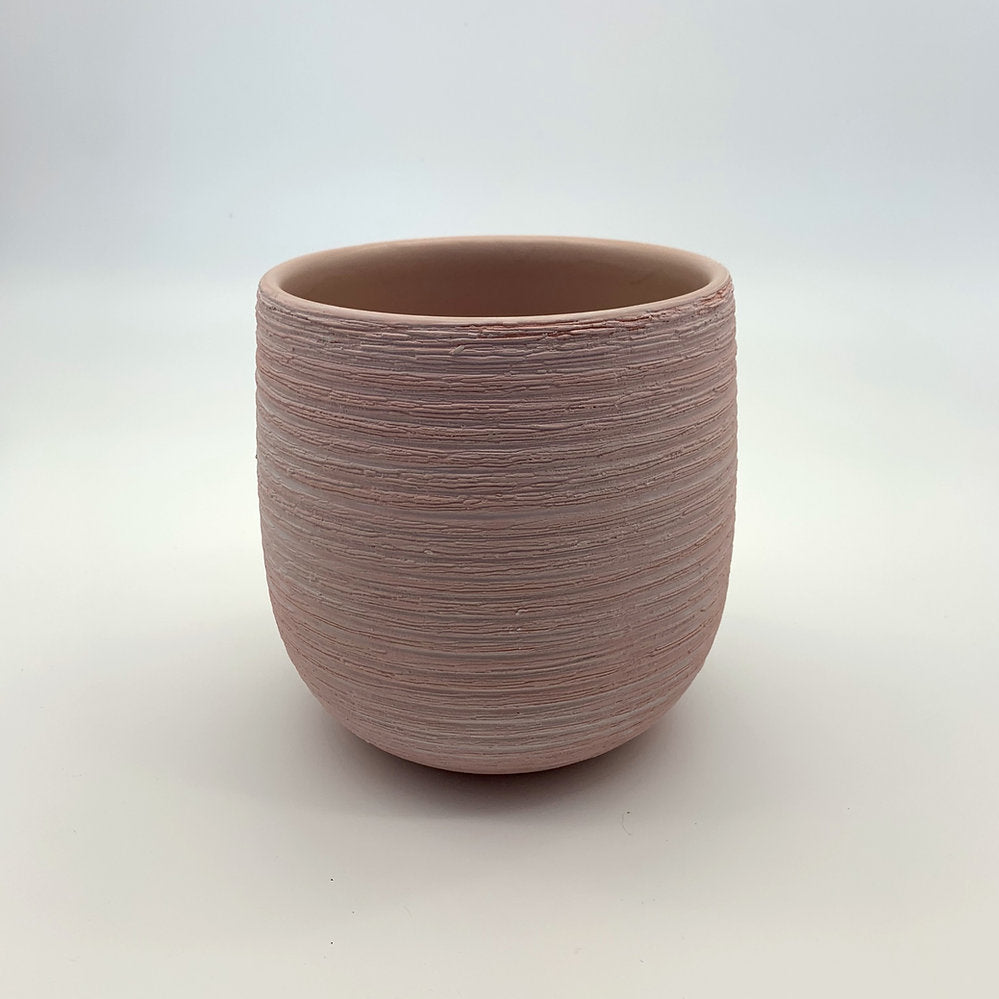 The Sidekick light pink round planter with subtle texture on a white backdrop.