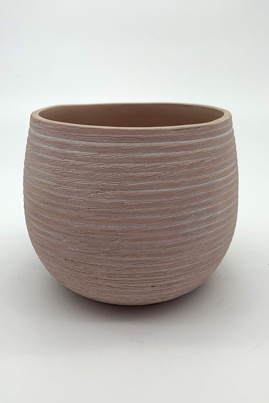The Sidekick terracotta-toned planter with a matte textured surface photographed on white.