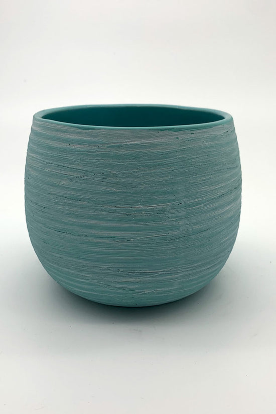 The Sidekick planter in turquoise with a smooth rounded shape on a white background.
