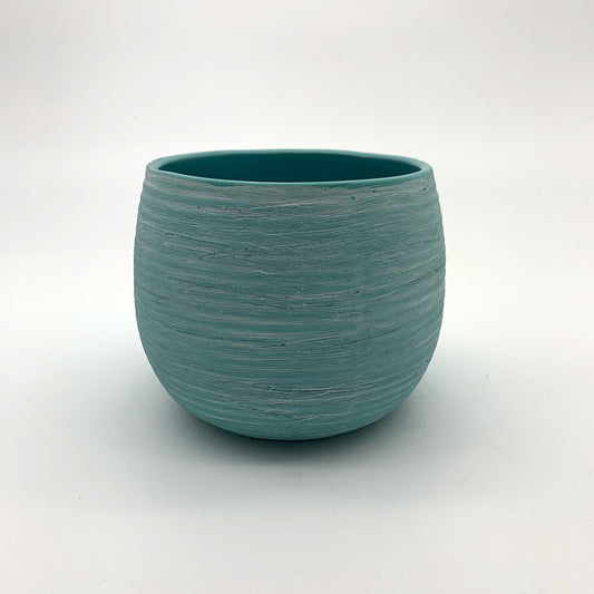 The Sidekick planter in turquoise with a smooth rounded shape on a white background.