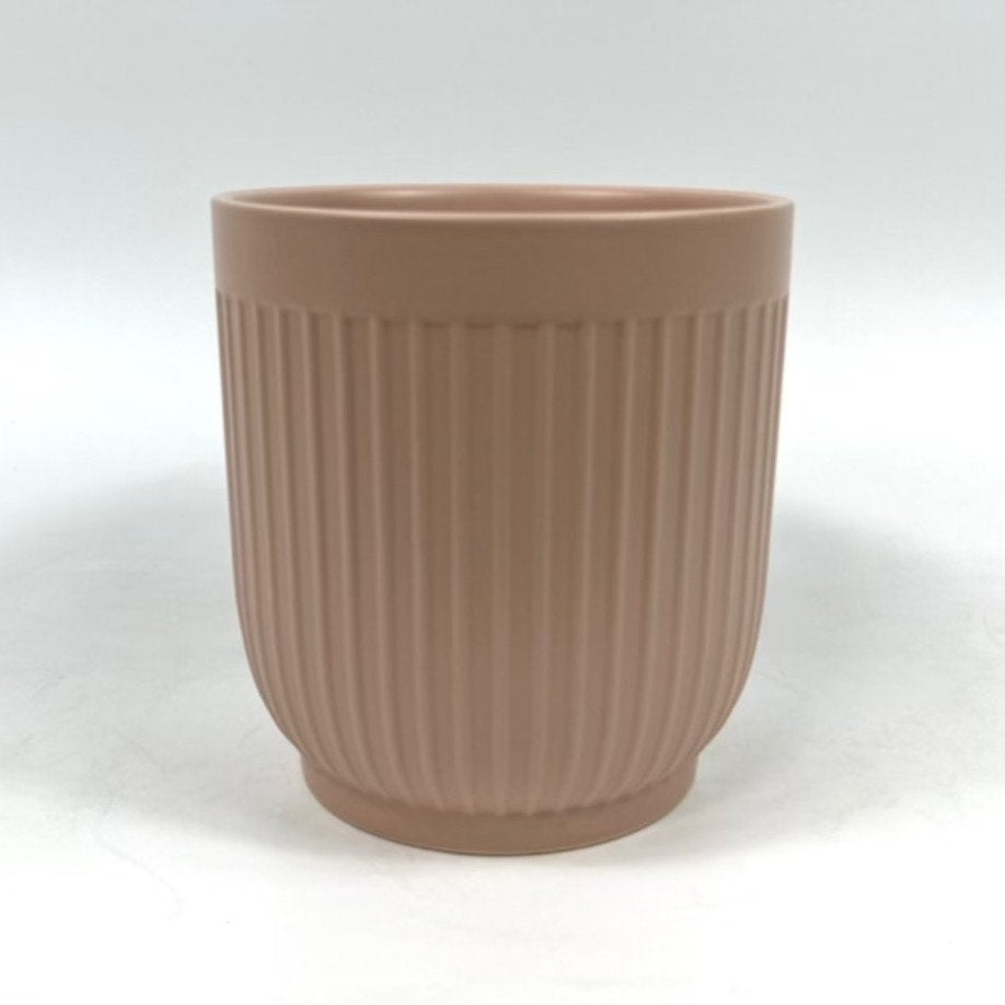 The Soft Shape planter in apricot with vertical ribbing photographed on a clean white background.