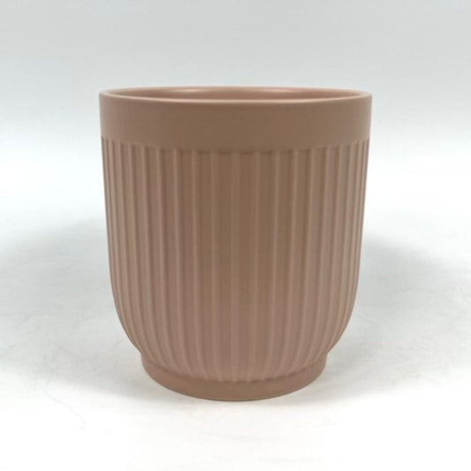 The Soft Shape planter in apricot with vertical ribbing photographed on a clean white background.