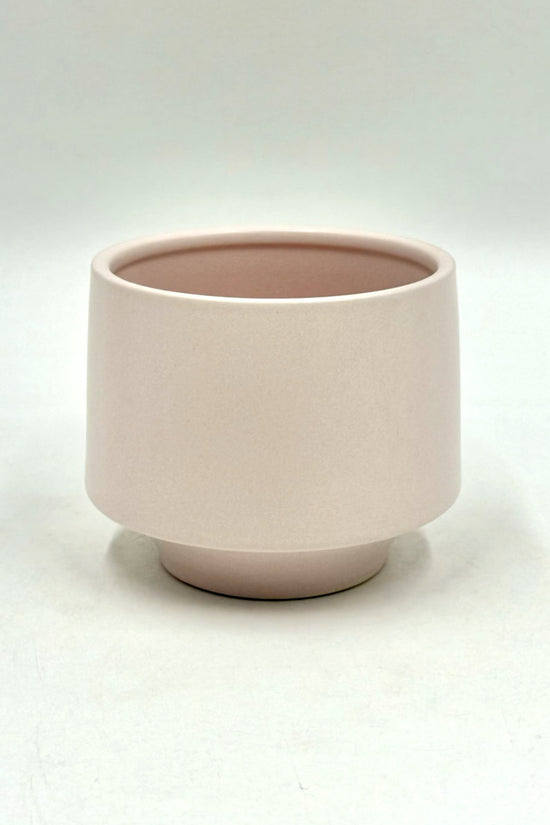 The Soft Spoken planter in soft pale pink with minimalist rounded design on a white backdrop.