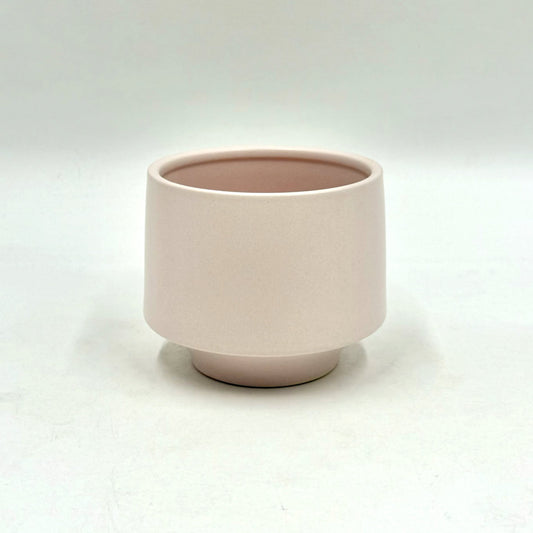 The Soft Spoken planter in soft pale pink with minimalist rounded design on a white backdrop.