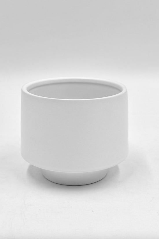 The Soft Spoken matte white planter with raised base and smooth finish photographed against a clean white background.