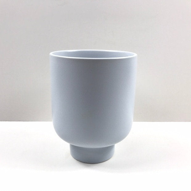 The Sunday Pot in duck egg blue with soft curved sides and pedestal base against a white backdrop.