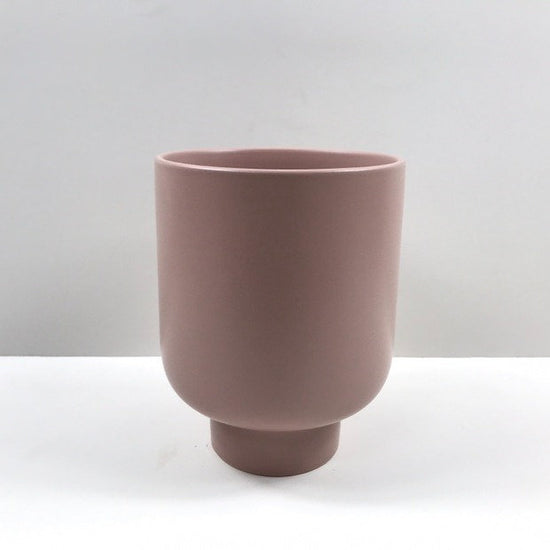 The Sunday Pot in dusty pink featuring a matte finish and pedestal form, photographed on a neutral background.