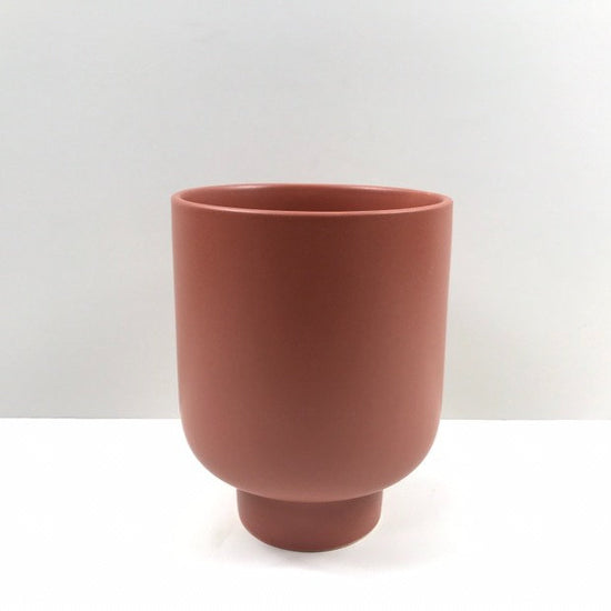 The Sunday Pot in terracotta with a smooth matte finish and pedestal base, photographed on a white background.
