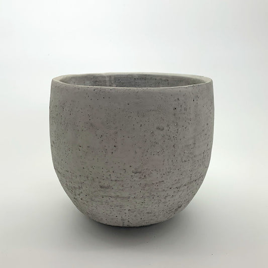 The Vibe Setter planter in natural cement with a smooth rounded shape, photographed on a clean white background.