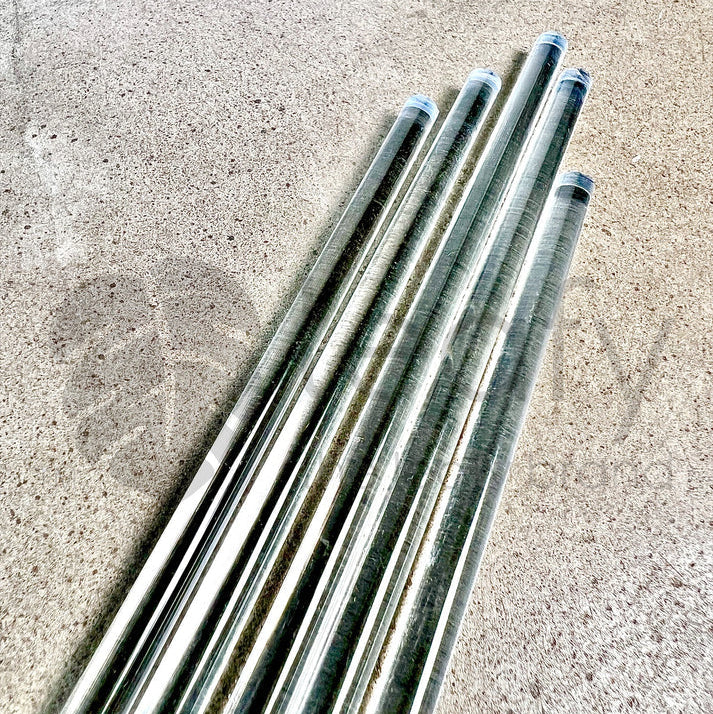 Four acrylic rods on a concrete surface